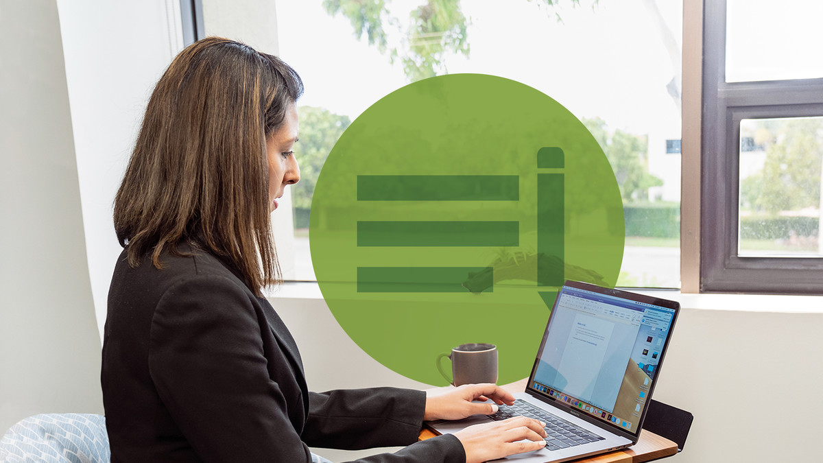 A woman working on a laptop in a business setting