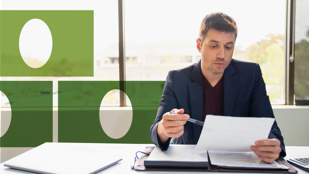 A man in an office setting reviewing business documents