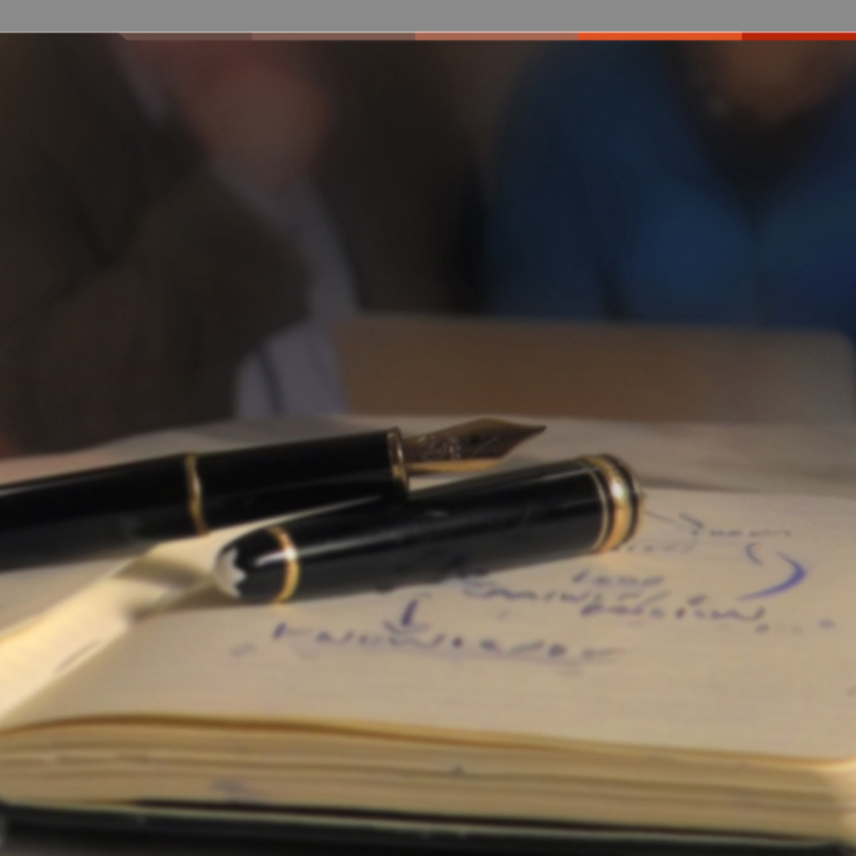 A fountain pen on a journal