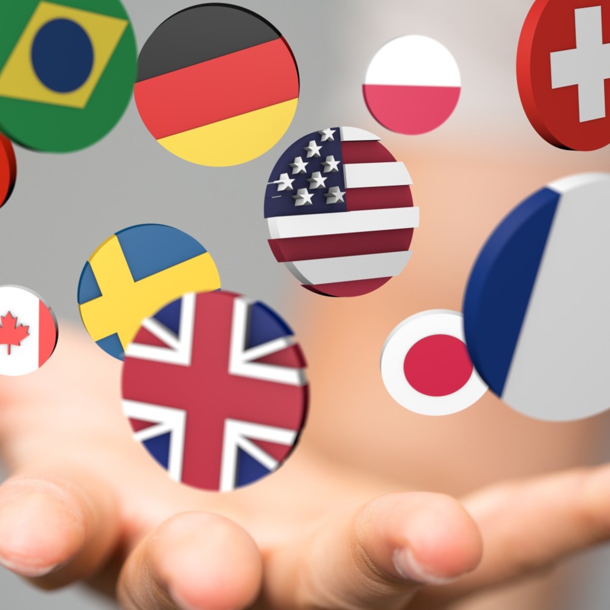 A hand throwing coins that have images of various national flags.