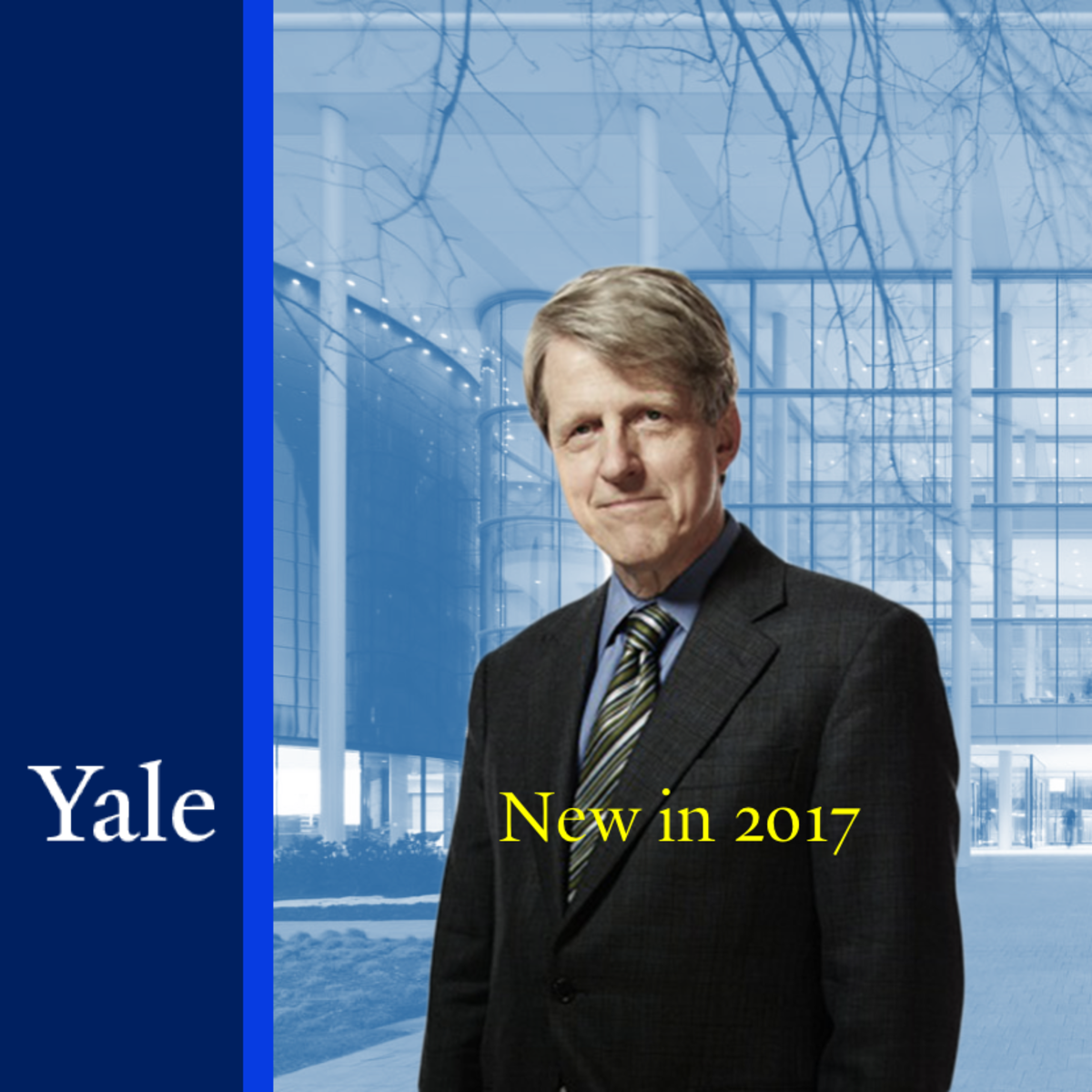A man standing next to the Yale logo